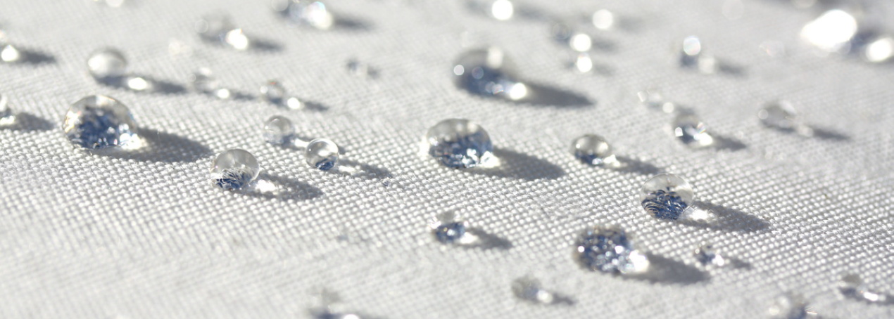 C0 DWR Durable Water Repellent: Eco-Friendly Fabric Protection That Performs Water droplets beading on fabric treated with C0 DWR durable water repellent finish