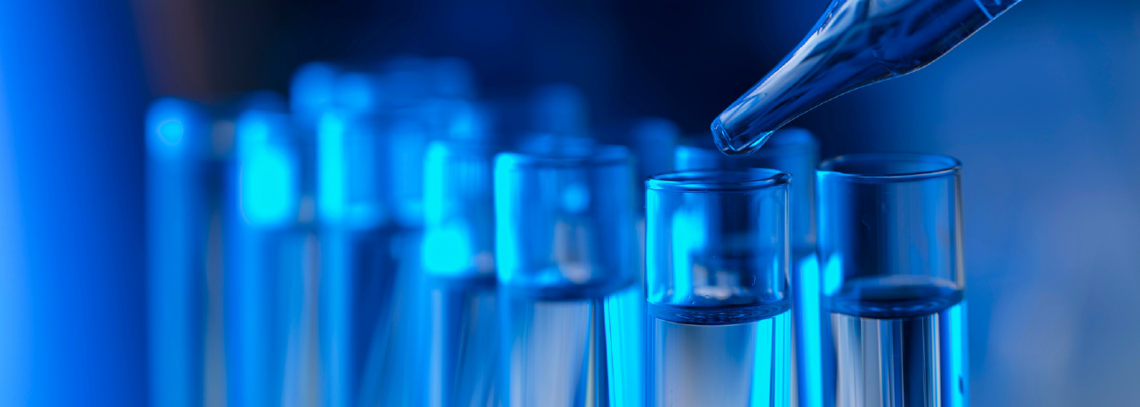 Laboratory test tubes and pipette representing PFAS chemical testing for textiles